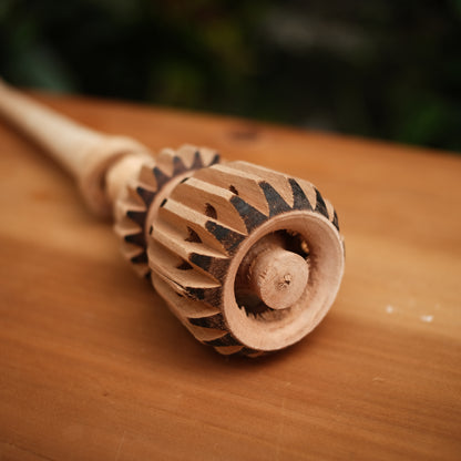 Close-up of carved wooden cacao whisk showing intricate detail, molinillo de chocolate, cocoa mixer, chocolate molinillo tool 