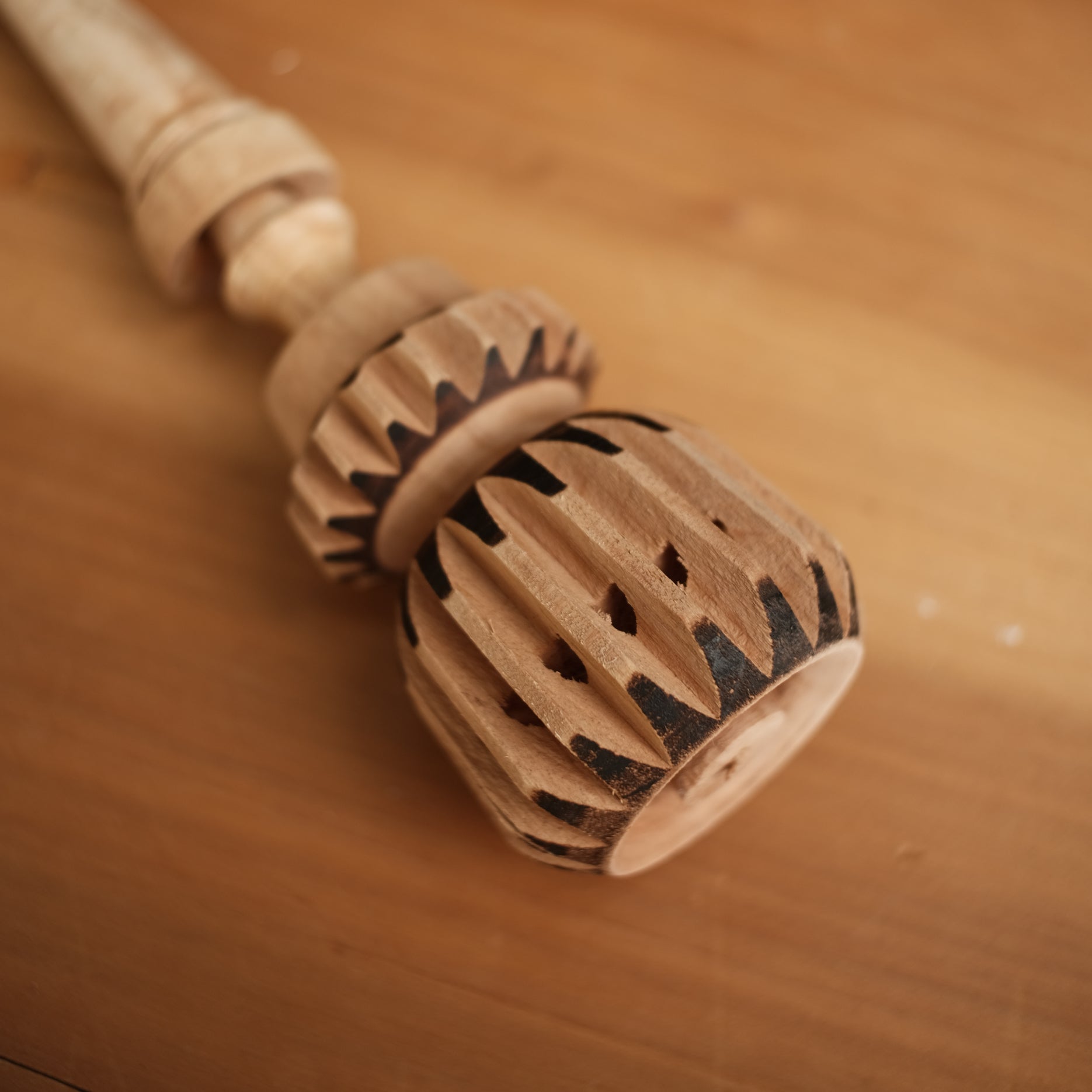 Traditional cacao ceremony stirring cacao in clay pot with molinillo de chocolate, cocoa mixer, ceremonial cacao tool