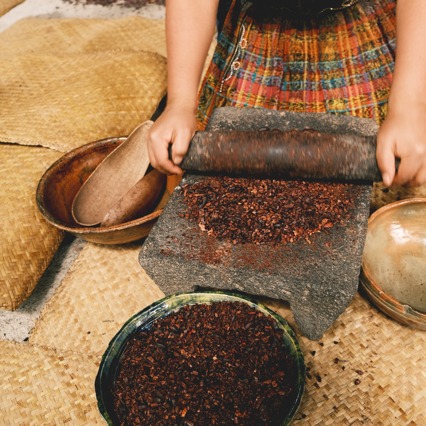 Hand-sifting freshly ground cacao nibs artisanal and sustainable cacao production, 100% dark chocolate, cacoa